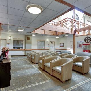 A spacious lobby with comfortable seating and a reception desk.