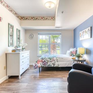 A bright and cozy bedroom with modern decor and ample natural light.