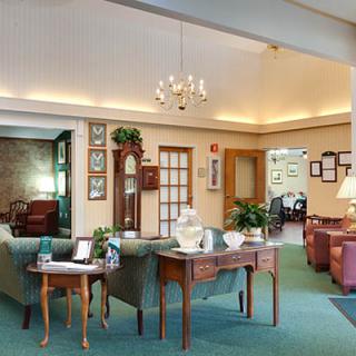 A cozy lobby area with comfortable seating, decorative accents, and a chandelier.
