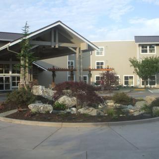 A modern building entrance with landscaped surroundings.