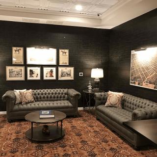 A stylish living room with dark walls, plush sofas, and cozy lighting.