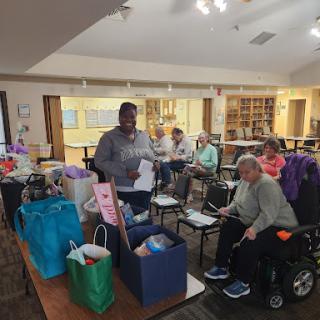 Seniors enjoying a community event with volunteers at the local senior center.