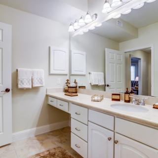 A well-lit bathroom with a spacious countertop and mirror.