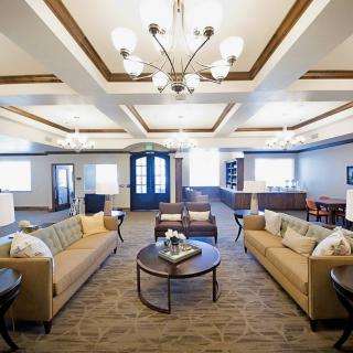 A luxurious living room with elegant furnishings and a chandelier.