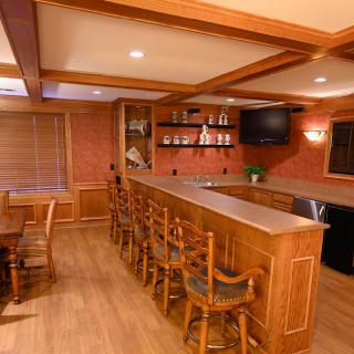 A cozy home bar setup with wooden furnishings and a warm ambiance.
