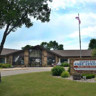 The entrance of a community center featuring a welcoming sign and an American flag.