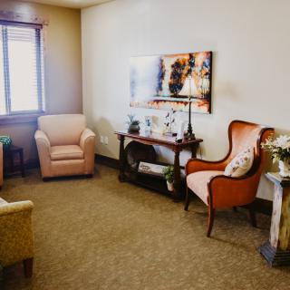A cozy living room with a mix of comfortable chairs and elegant decor.