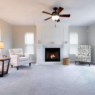 A cozy living room with a fireplace and comfortable seating.