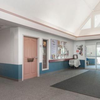 A quiet waiting room with a reception desk and a closed door.