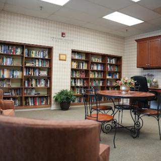 A cozy reading area with bookshelves full of books and a small table for study or relaxation.