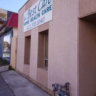 A view of a health care facility with a large sign visible on its facade.