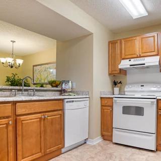 A cozy kitchen with wooden cabinets and modern appliances.