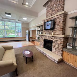 A cozy lobby area featuring a stone fireplace and comfortable seating.