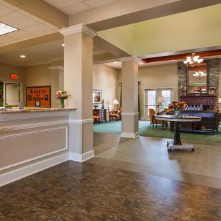 A welcoming hotel lobby with a reception desk and comfortable seating area.