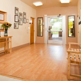 A welcoming lobby area with wooden flooring and simple decor.