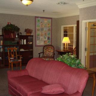 Cozy living room with a red sofa and warm lighting.