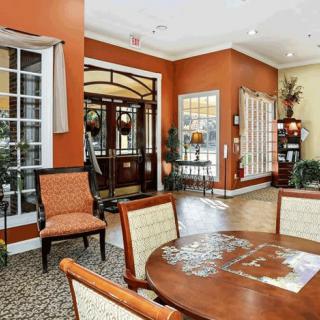A stylish hotel lobby featuring elegant furniture and warm, inviting decor.