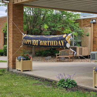 A festive banner celebrating a special milestone, 'Happy 100 Birthday!'