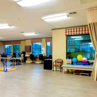 A rehabilitation room equipped with exercise and therapy tools.
