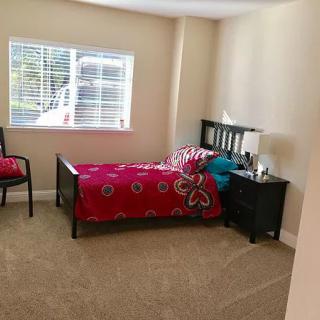 A cozy bedroom with a single bed and bright decor.
