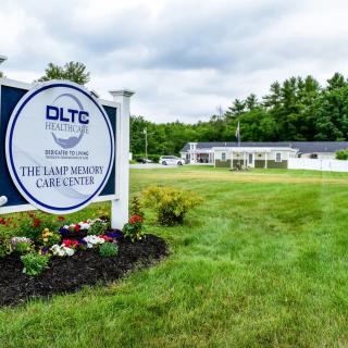 Exterior of a care center with a prominent sign and well-maintained landscaping.