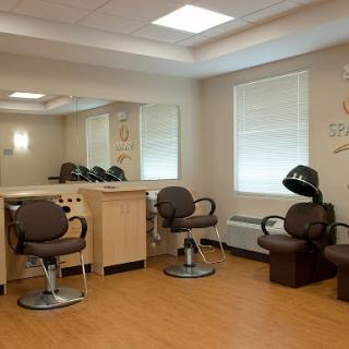 A modern hair salon interior with styling chairs and mirrors.