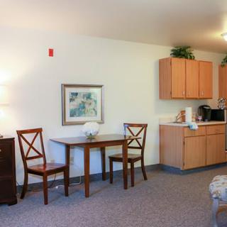 Cozy dining area with a small table and kitchenette.