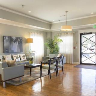 A modern living room with stylish furniture, artwork, and natural lighting.
