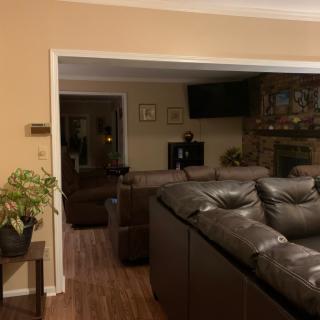 A cozy living room with a large sectional sofa, fireplace, and television.
