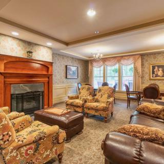 A cozy living room with elegant furniture and a warm fireplace.