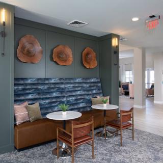 A modern cafe seating area with stylish furniture and unique wall art.