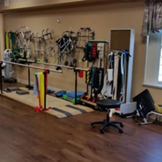 A physical therapy room equipped with various exercise and rehabilitation tools.
