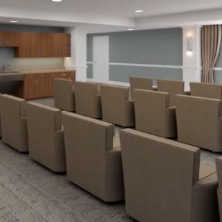 A modern conference room with comfortable seating and a projector screen.