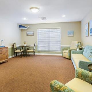 A cozy living room featuring comfortable seating and a dining area.