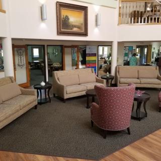 A cozy lobby with comfortable seating and artwork on the wall.