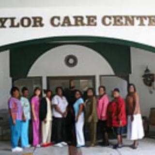 A group of people standing in front of a care center entrance.
