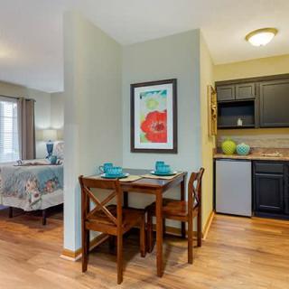 Cozy dining area with a small table and chairs adjacent to a compact kitchen.
