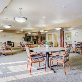 A spacious and well-lit dining area with tables and chairs arranged neatly.