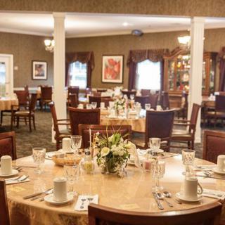 An elegant dining room with tables set for guests.