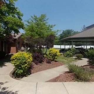 A beautifully landscaped garden with a winding pathway leading to a gazebo.