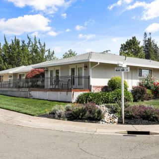 A suburban house with well-maintained landscaping on a clear day.