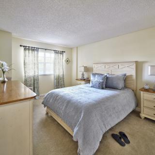 A cozy bedroom with a comfortable bed, soft lighting, and elegant decor.