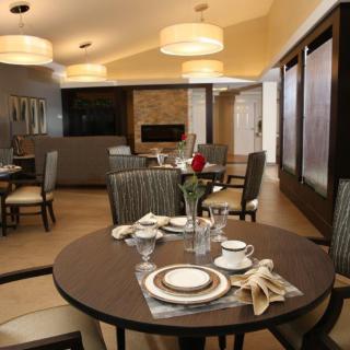 A modern dining room with elegantly set tables and comfortable seating.