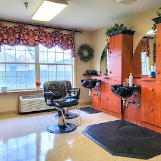 A well-lit barbershop featuring styling stations and a comfortable barber chair, creating an inviting atmosphere for clients.