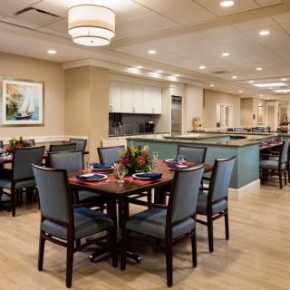 A modern dining room with neatly arranged tables and chairs.