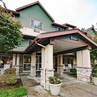 A view of a residential building entrance with a covered walkway.
