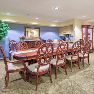 Elegant dining or meeting room with a long wooden table and chairs.