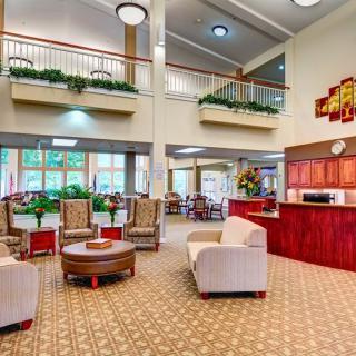 A spacious and modern hotel lobby with comfortable seating and a reception desk.