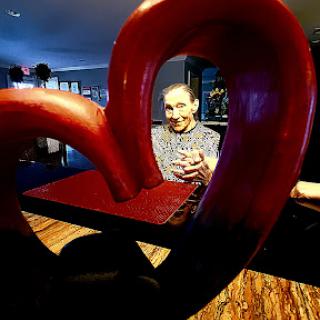 A playful portrait framed by a heart-shaped art installation.