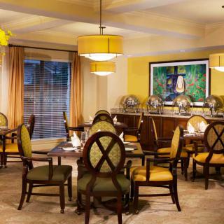 A cozy dining room with elegant furnishings and warm lighting.